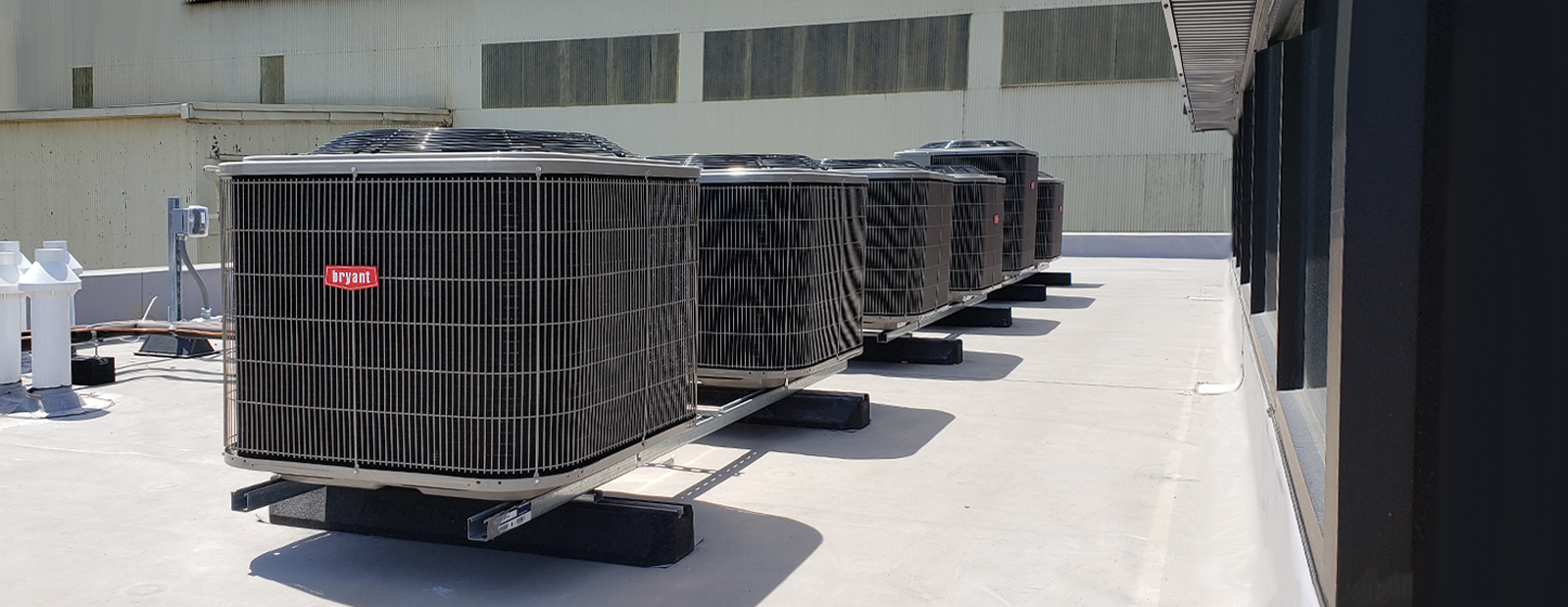 Row of installed Byrant brand air conditioners