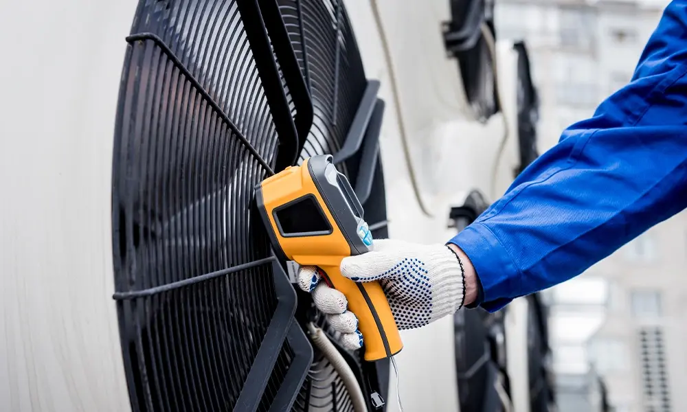 Technician scanning large industrial fan