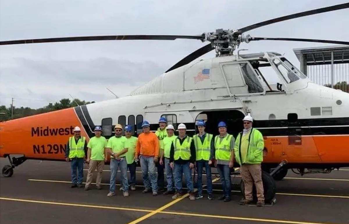 YORK team standing in front of a helicopter